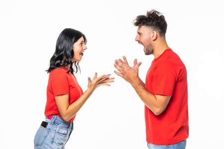 Angry couple shouting at each other on white background