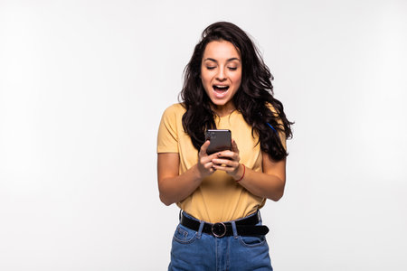 Young beautiful happy woman using smart phone. Excited surprised woman texting on her mobile phone...