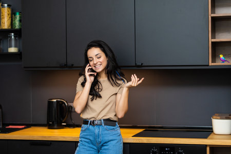 Cheerful young woman talking on the phoneの写真素材