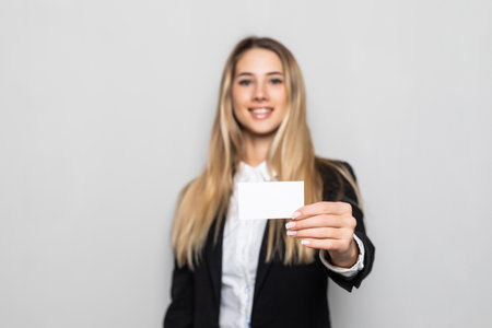 Business woman holding business card on white backgroundの写真素材