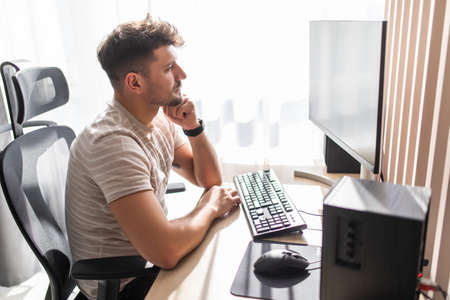 Smiling designer working at his desk in modern officeの写真素材