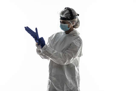 Woman wearing gloves with biohazard chemica protective suit on white background.