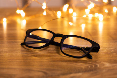 A pair of glasses on the table against a bokeh background. Selective focusの写真素材