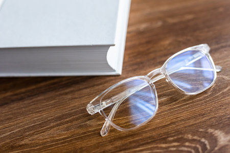 Close up Eyes glasses on books at table at home. Desk work at home.