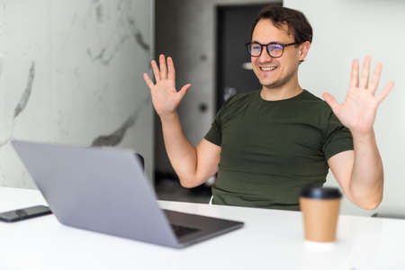 Young man has video call conference in morning at home.