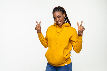 Beautiful African American woman peace sign isolated on white backgroundの写真素材