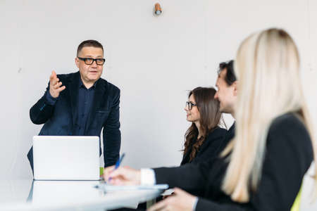 Businesspeople discussing together in conference room during meeting at officeの写真素材