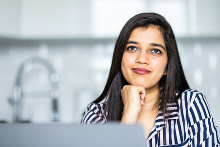 beautiful young woman using laptop at homeの写真素材