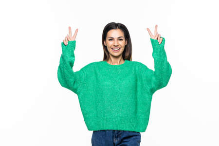 Beautiful young woman showing peace victory sign on white background