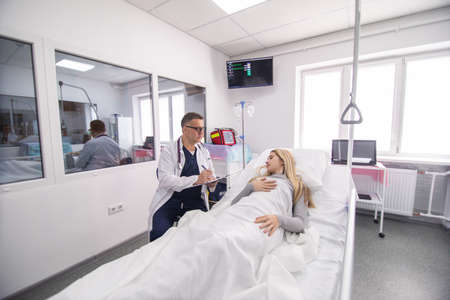 Doctor taking care of patient in hospital room