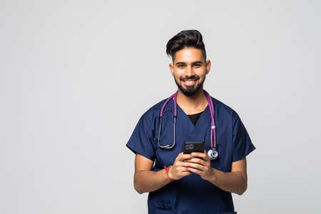Photo of young doctor using his smartphoneの写真素材