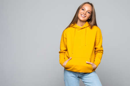Young pretty woman in yellow hodie isolated on white background