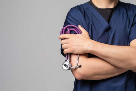 Close up of a doctors lab coat over a white backgroundの写真素材