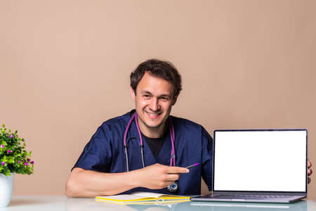 Young Doctor consulting presenting results on blank Screen computer sitting at table