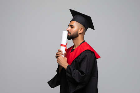 Young indian Graduation Man Holding Certificate Isolated On Gray Backgroundの写真素材
