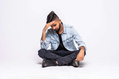 Young disappointed man isolated on white background.の写真素材