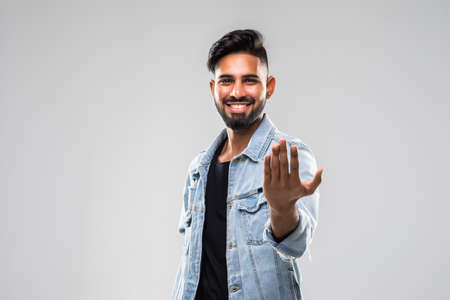 Young man doing a welcome gesture on white backgorund