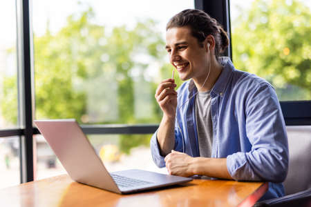 Man have business meeting via video call in a cafe