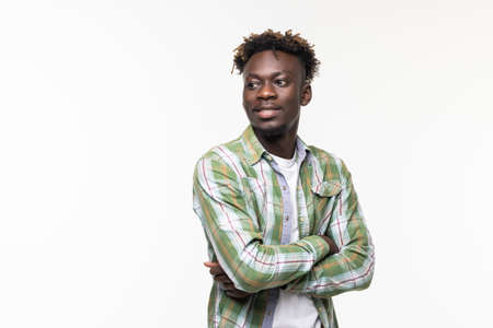 Smiling african man with crossed arms on white backgroundの写真素材