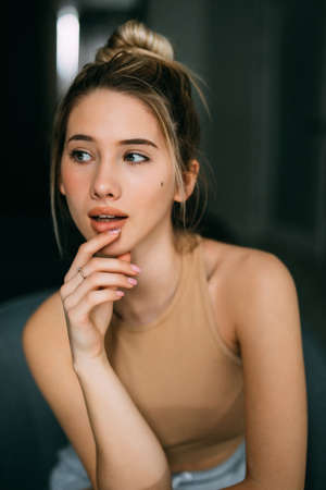 Young beautiful happy woman sitting on the armchair at homeの写真素材
