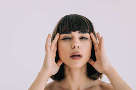 Beautiful sensual woman touching her face. Beauty and skincare concept.の写真素材