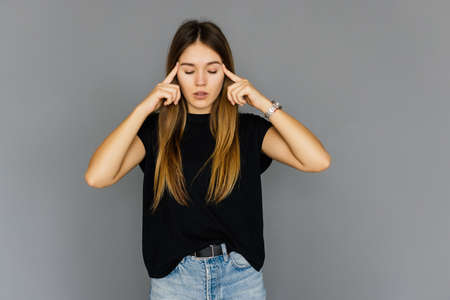 Woman puts hands on the head, isolated on white. Concept of problems and headacheの写真素材