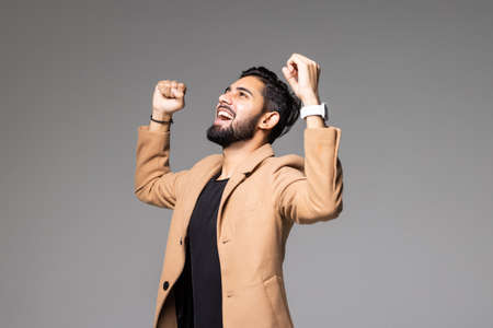 Cheerful businessman celebrating his success isolated on a white background