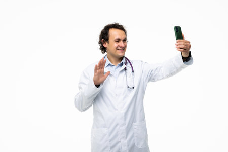 Confident and successful doctor or medic taking a selfie with smartphoneの写真素材