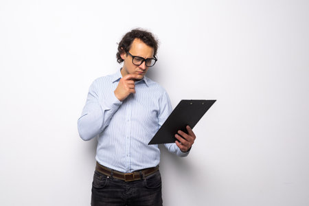 businessman writing on clipboard over white backgroundの写真素材