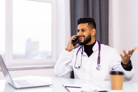 professional medical doctor talking on mobile phone in hospitalの写真素材