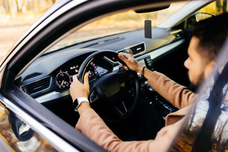 Front view of young asian man driving car.の写真素材