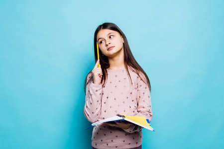 happy child making notes on blue background, childhoodの写真素材