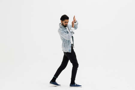 Young man standing scared over white studio background.