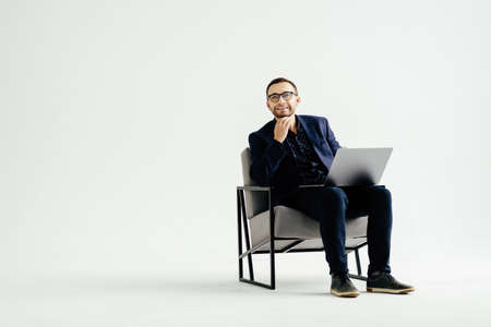 Pleasant positive business man using laptop