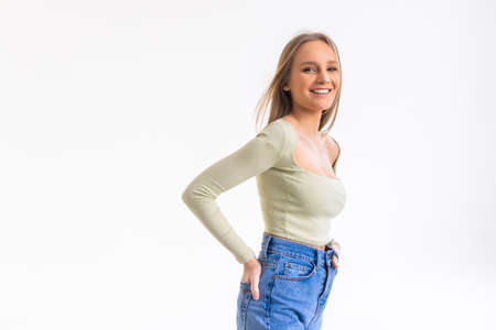 Portrait of authentic happy woman without makeup, smiling at camera, standing cute against white...