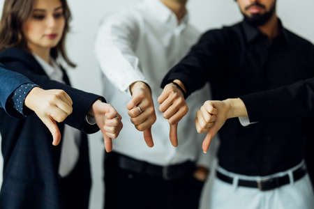 mixed team showing thumb down
