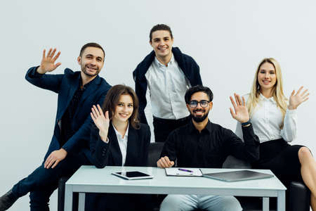 Company employees sitting at conference table in office having meeting