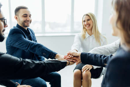Diverse multiracial business team giving a high fives gesture as they celebrate in a conference room...