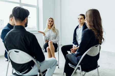 Corporate business team meeting in a modern open plan officeの写真素材