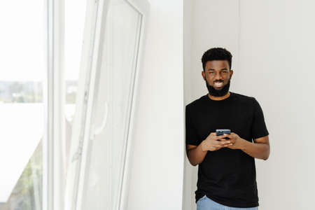 portrait of young african business man smiling and looking happy