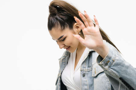 Young woman with sincere emotions wearing jean blue jacket isolated over white background with free space and showing no gesture with hand palm. stop gestureの写真素材