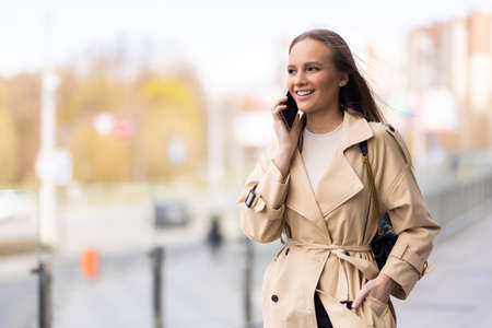 Portrait of woman calling by phone on the street
