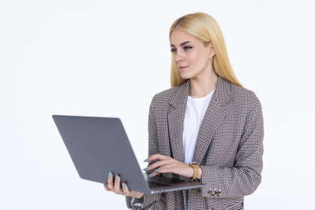 Portrait of a businesswoman working on laptop computer isolated over white background