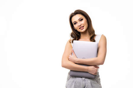 Portrait of young office woman, entrepreneur answer clients on laptop, working with computer with happy face, standing over white backgroundの写真素材