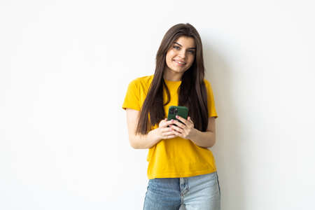 Portrait of Beautiful Young Business woman using mobile phone isolated on white backgroundの写真素材