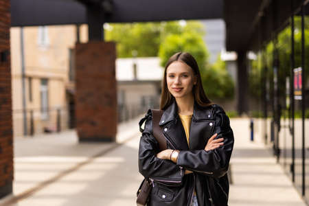 Portrait of a young happy and pretty girl walking streetの写真素材