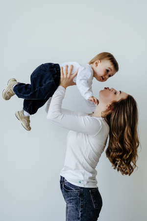 young mother with her son over white backgroundの写真素材