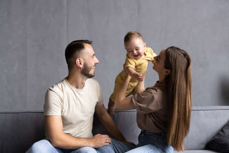 Happy family on their sofa at homeの写真素材