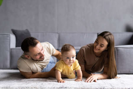 Cute baby with parents at home