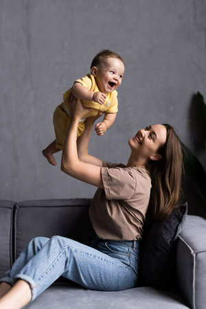 happy loving family. mother playing with her baby in the bedroom.の写真素材